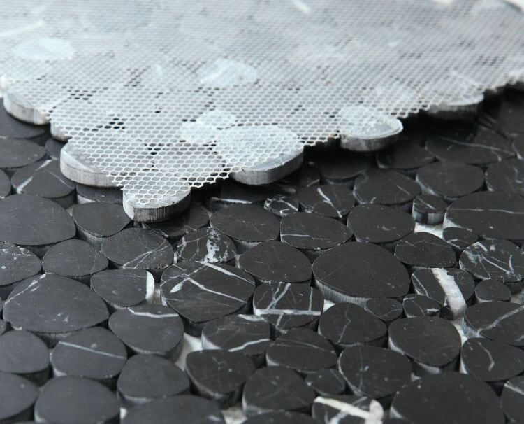 Close-up of Aphrodite Marquina honed heart-shaped mosaics, featuring authentic Nero Marquina marble in a sophisticated black finish.