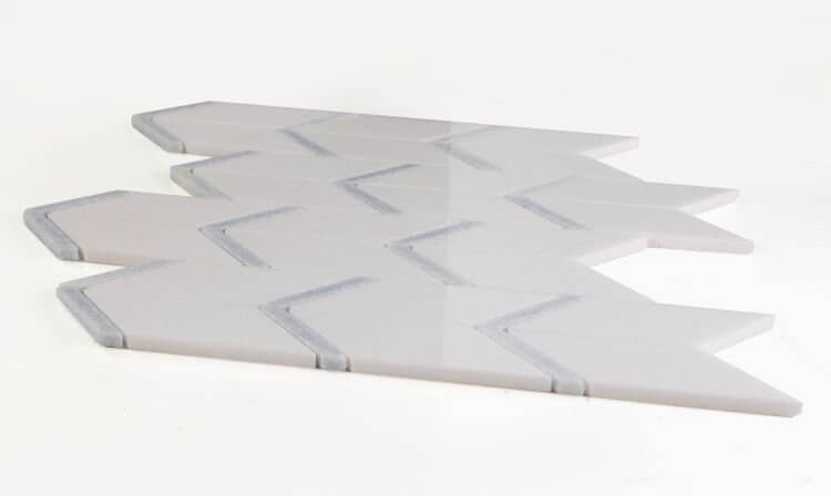 Thassos Blue Chevron 12 x 12.75 marble tile featuring a contemporary arrow pattern in elegant white and blue.