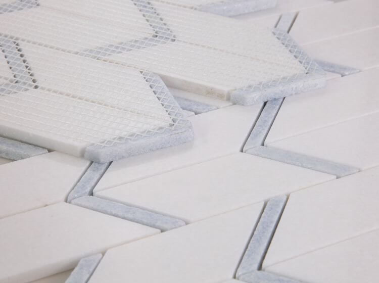 Thassos Blue Chevron marble tile showcasing a contemporary arrow pattern with white and blue hues.