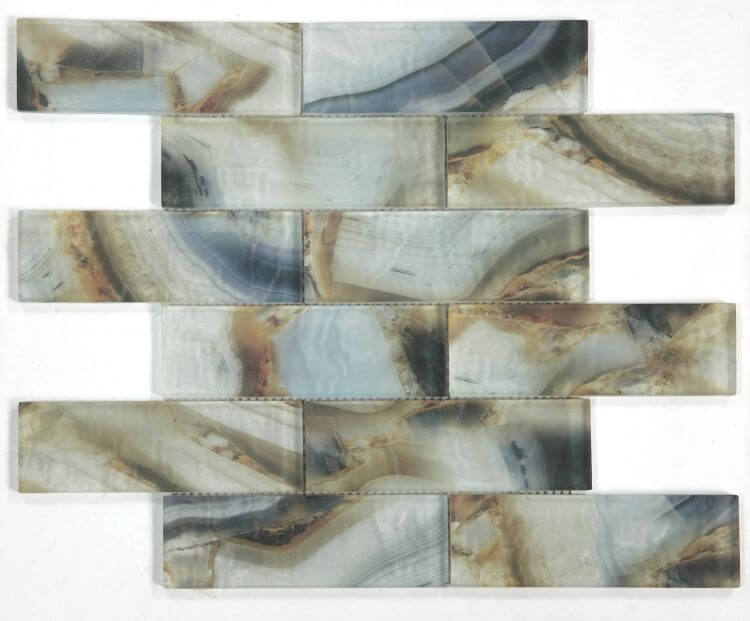 Art Onyx Mauna 11.75 x 11.75 glass mosaic tile in a linear brick pattern featuring blue, brown, and beige hues.