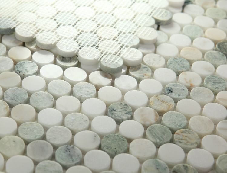 Calacatta Green Penny Round polished mosaic tile featuring white and green veining patterns.