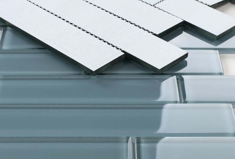 Close-up of Casale Blue Shining glass tiles in subway layout with polished finish, sizes include 2x12, 2x8, 2x6, and 2x4.