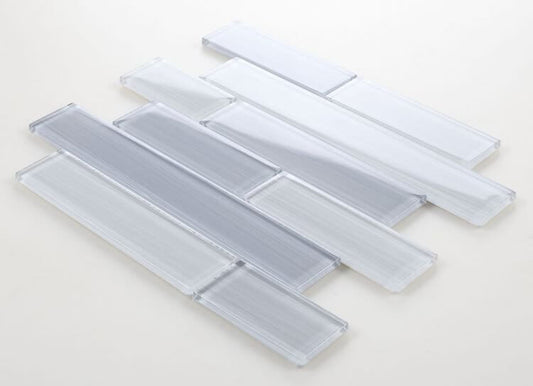 Polished light grey glass tiles in subway layout, featuring various chip sizes for swimming pool installation.