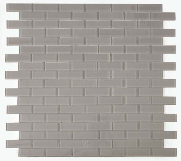 Polished grey glass tile in subway layout, 11.75x11.75, ideal for swimming pools and modern interiors.