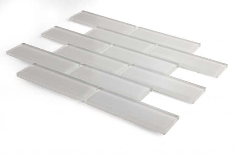 Casale Light 11.75x11.75 polished light grey glass tiles in subway layout for swimming pool installation.