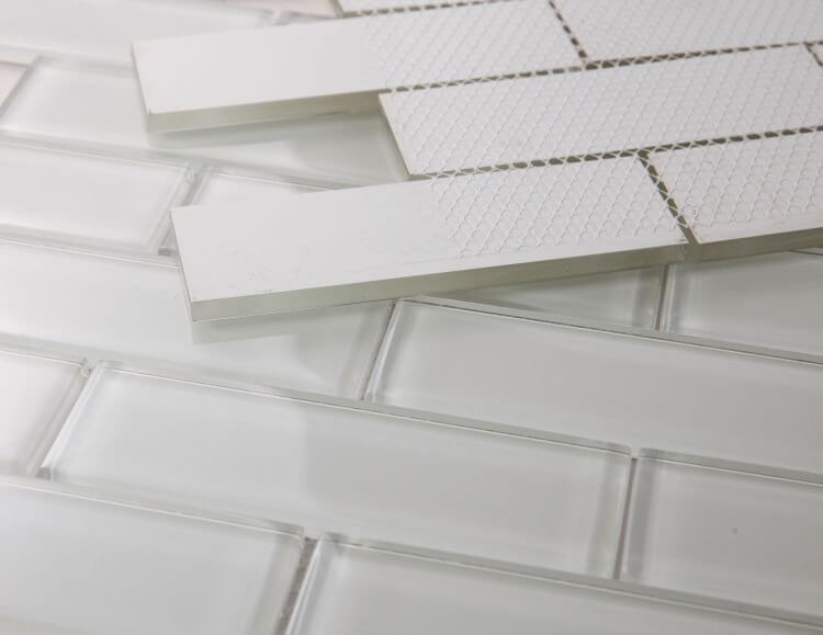 Polished white glass tiles in subway layout, featuring 2x6 chip sizes for swimming pool installation.