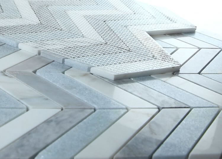 Chevron vivid blue marble mosaic tile showcasing Carrara white and Bardiglio gray patterns.