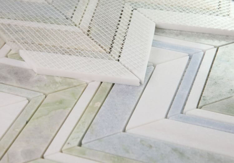 Chevron Spring Marble Mosaic showcasing vibrant Green Onyx, Argentina Blue, and White Thassos tiles in a polished finish.