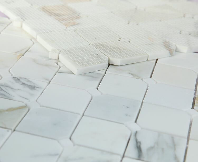 Close-up of Calacatta Gold 11.75 x 11.75 mosaic tile featuring polished finish and unique clipped pattern.