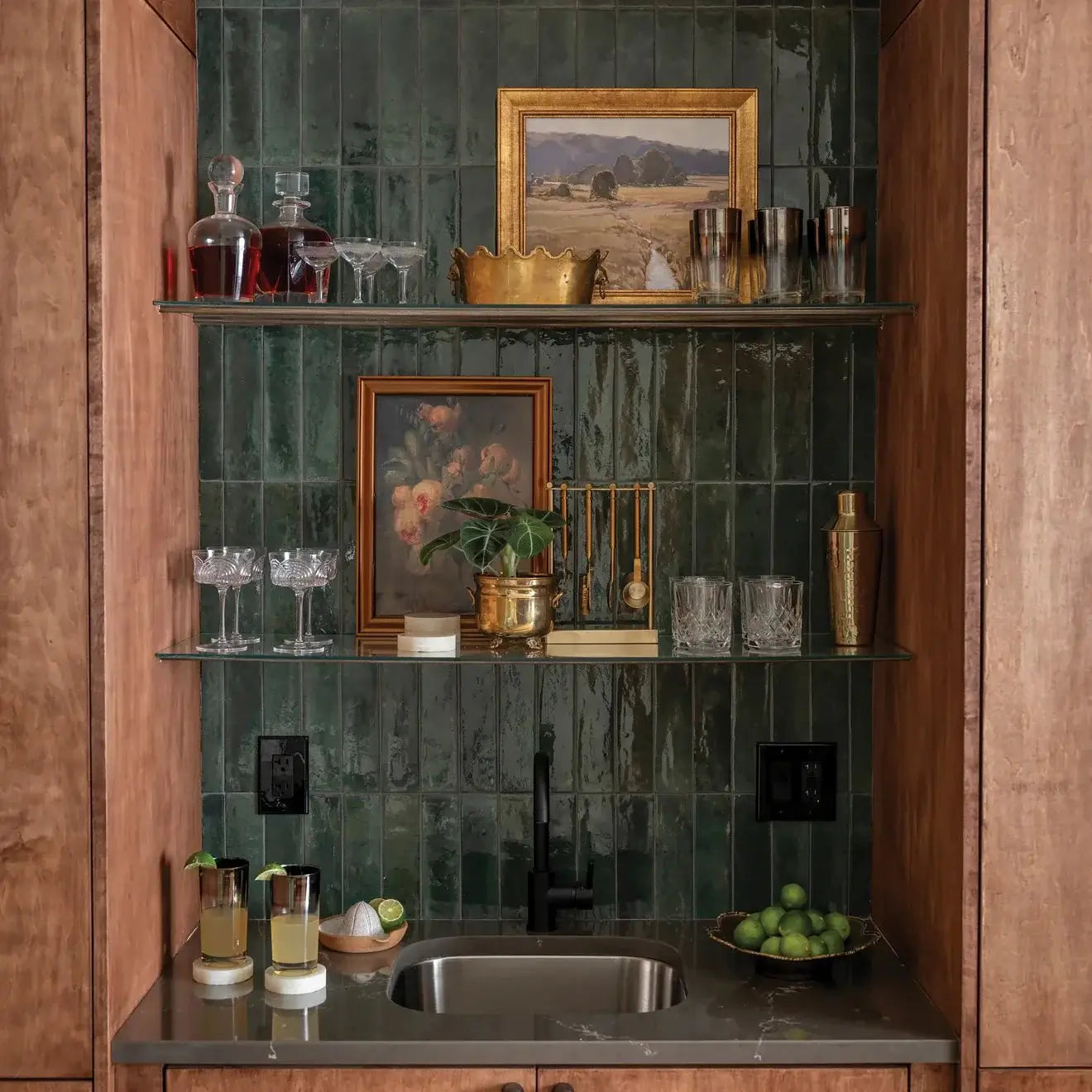 Stylish home bar featuring Cloé 2.5" x 8" glossy green ceramic tile, elegant glassware, and decor.