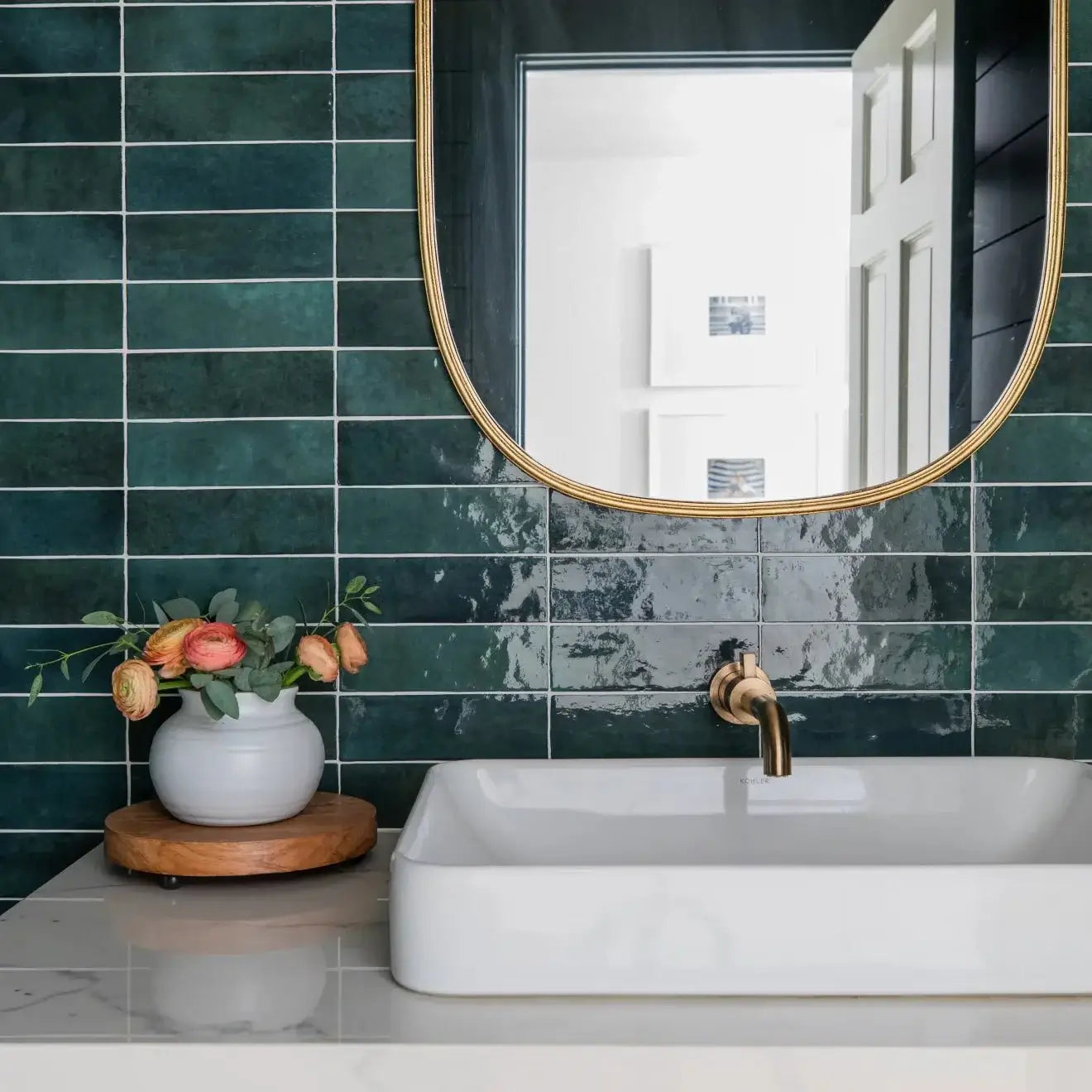Cloé 2.5" x 8" glossy green ceramic tile in stylish bathroom design with a vessel sink and mirror.