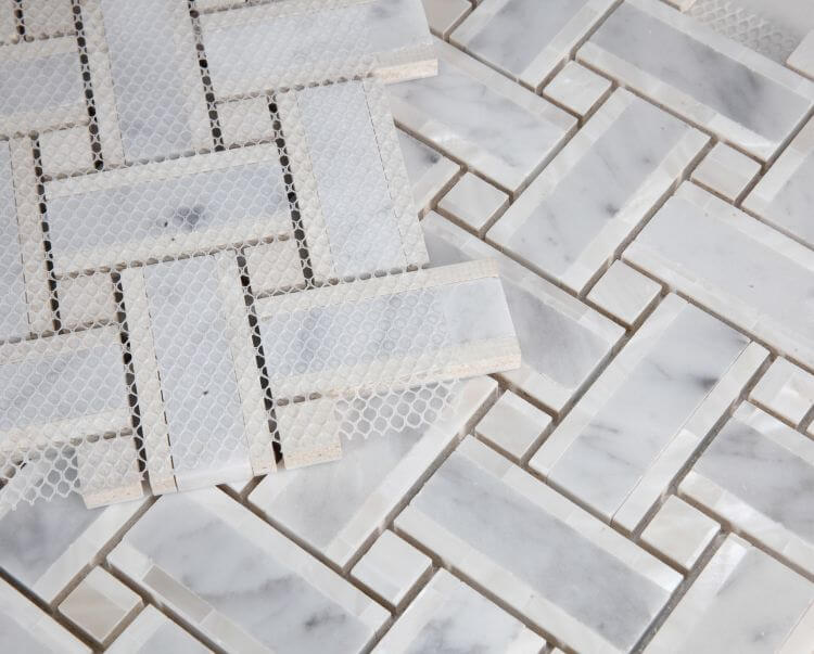 Diana Cross Carrara 12.25 x 12.25 tile showcasing Carrara marble and white pearl in a cross weaved design on a mosaic background.