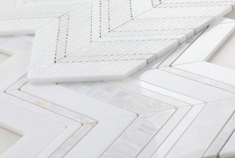 Diana Ravenna mosaic tiles in white marble and pearl, featuring a chevron pattern, 11.75 x 12.25 inches.