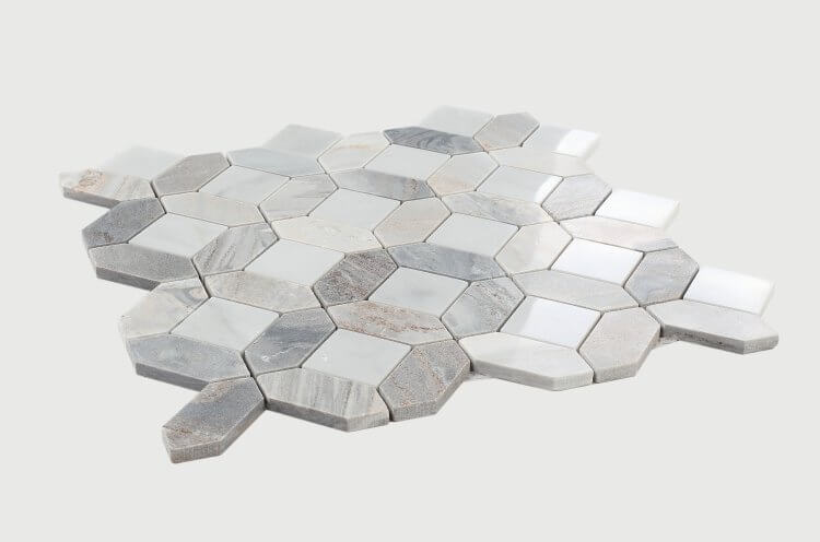 Dimensional Diamond Carrara Blue Sky mosaic tile showcasing soft blues, gentle grays, and whites in unique hexagonal shapes.