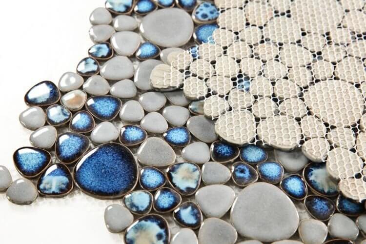Poseidon Cielo 11.5x11.5 pebble mosaic tile featuring shades of blue and gray in a calming design.
