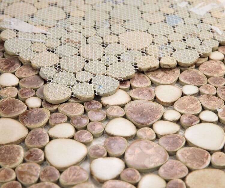 Earthy pebble mosaic tile in shades of beige, cream, and brown, perfect for pool areas.