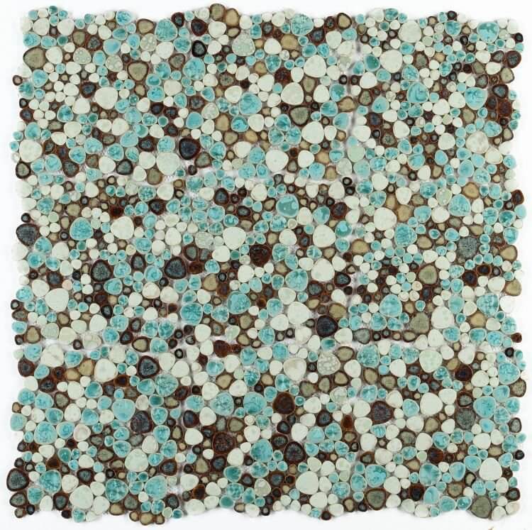 A vibrant mosaic tile featuring a blend of turquoise, brown, and white pebbles arranged in an 11.5 x 11.5 inch pattern.
