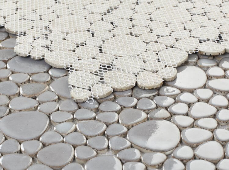Poseidon Grey 11.5x11.5 pebble mosaic tile showcasing natural grey pebbles in light silver and deep charcoal tones.