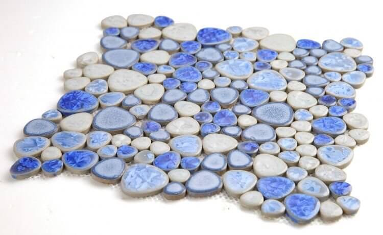 Poseidon Sapphire 11.5 x 11.5 Pebble Mosaic Tile featuring blue and gray porcelain stones for modern pool designs.