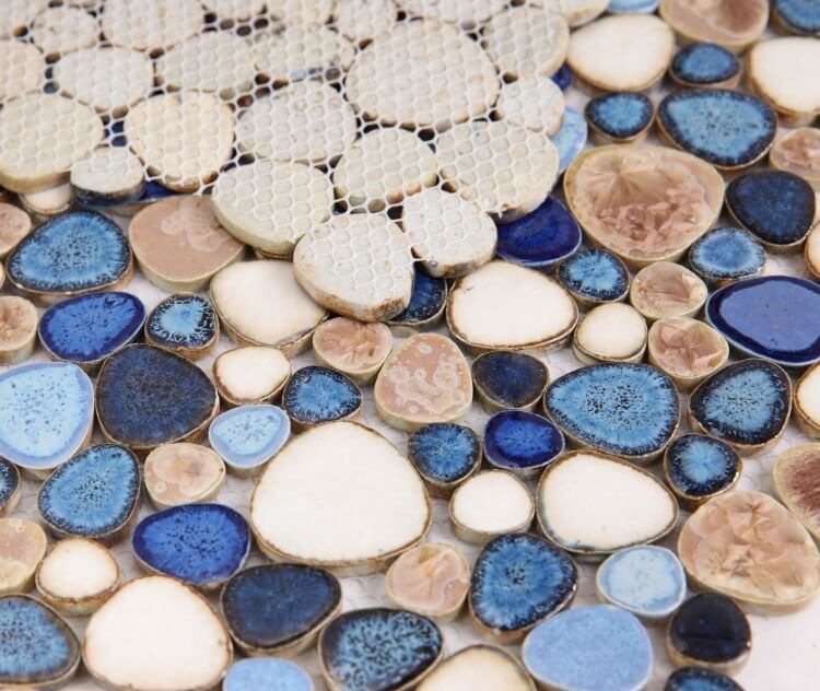 Close-up of Poseidon Seaside 11.5 x 11.5 Pebble Mosaic Tile featuring blue, beige, and cream porcelain pebbles.