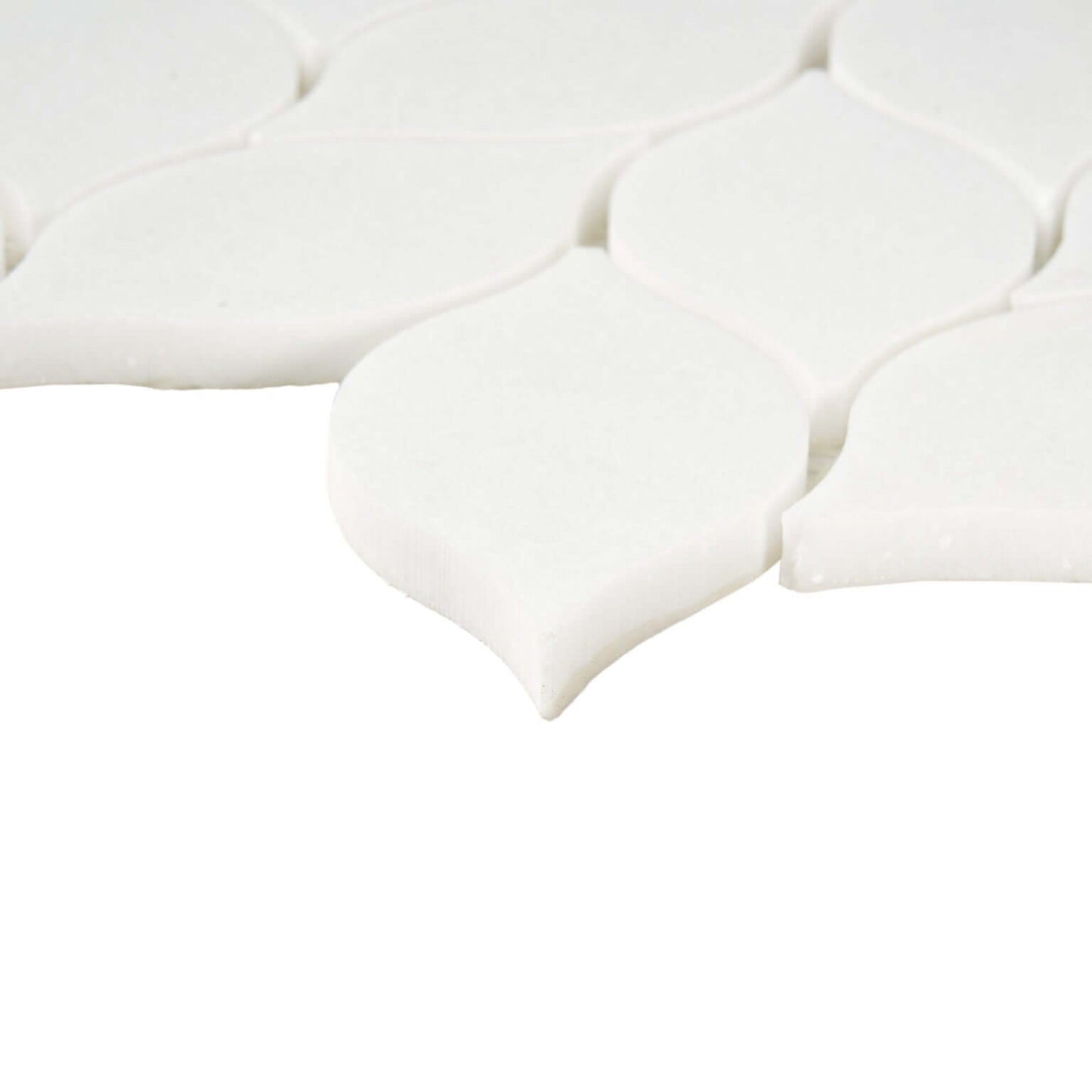 Thassos white leaf pattern marble mosaic tile showing polished white surface and elegant leaf design.