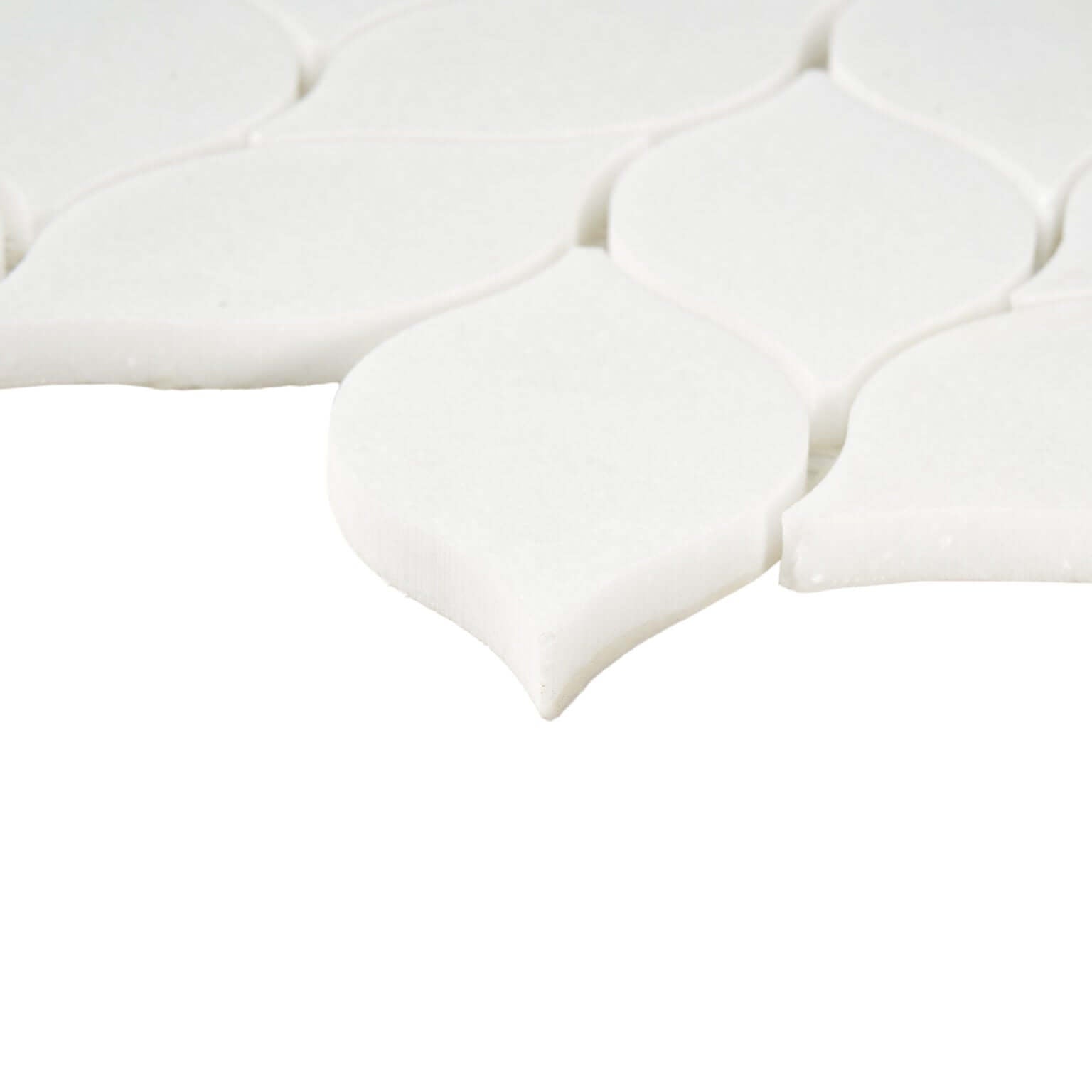 Thassos white leaf pattern marble mosaic tile showing polished white surface and elegant leaf design.
